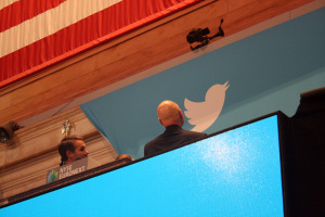 Actor Patrick Stewart examines the Twitter logo as he stands next to child activist Vivienne Harr, who helped him ring the opening bell.