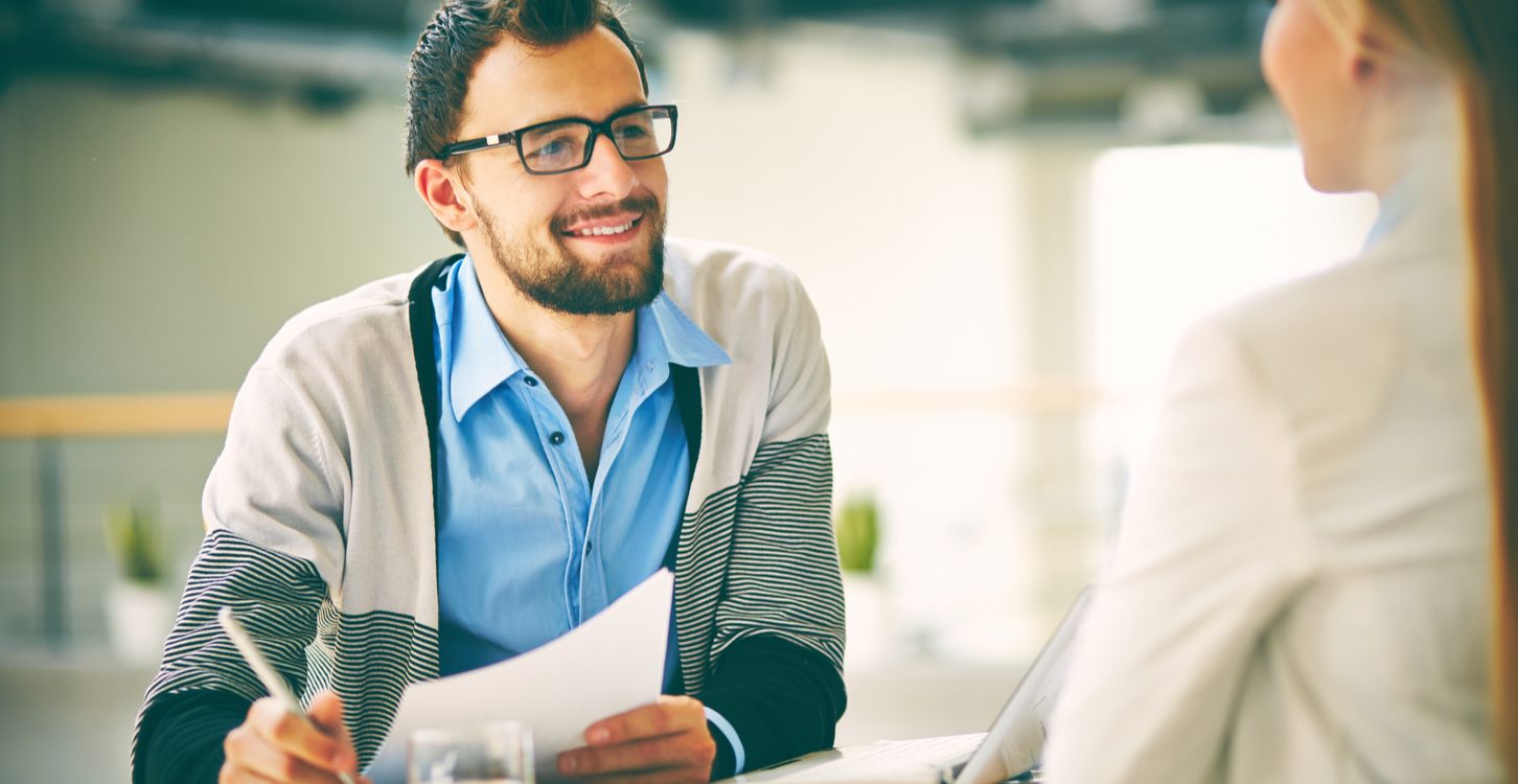man smiling at colleague