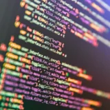 Programming Javascript on laptop computer screen. Program code PHP HTML CSS of site. Computer code on laptop (web developing). Template of website, selective focus